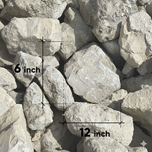 Side-by-side riprap stone size comparison showing 6-inch and 12-inch rocks